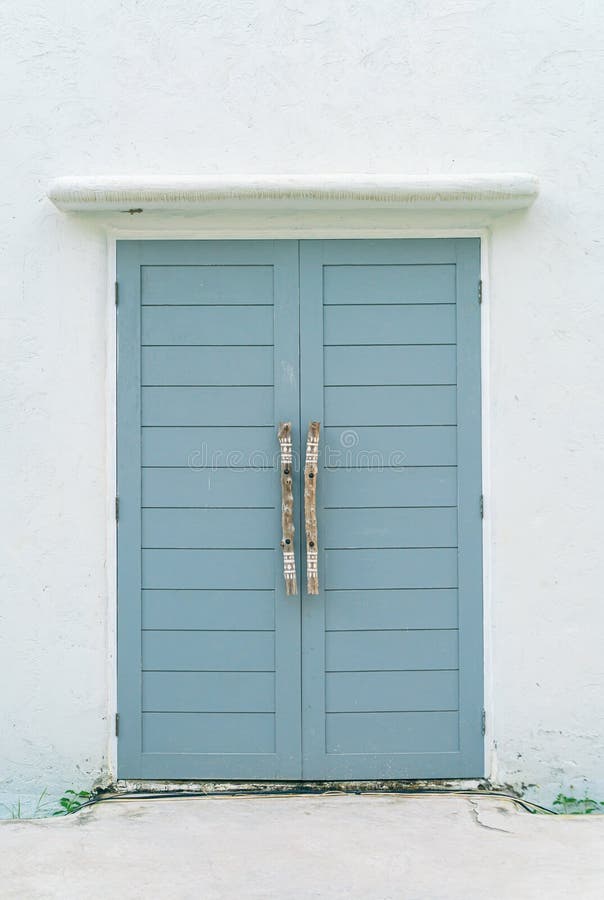 Grey door with white wall stock photo. Image of design 240580230