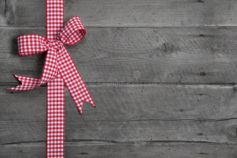 Grey wooden background with red and white checkered bow as border royalty free stock photos Grey wooden background with red and white checkered bow as border royalty free stock photos