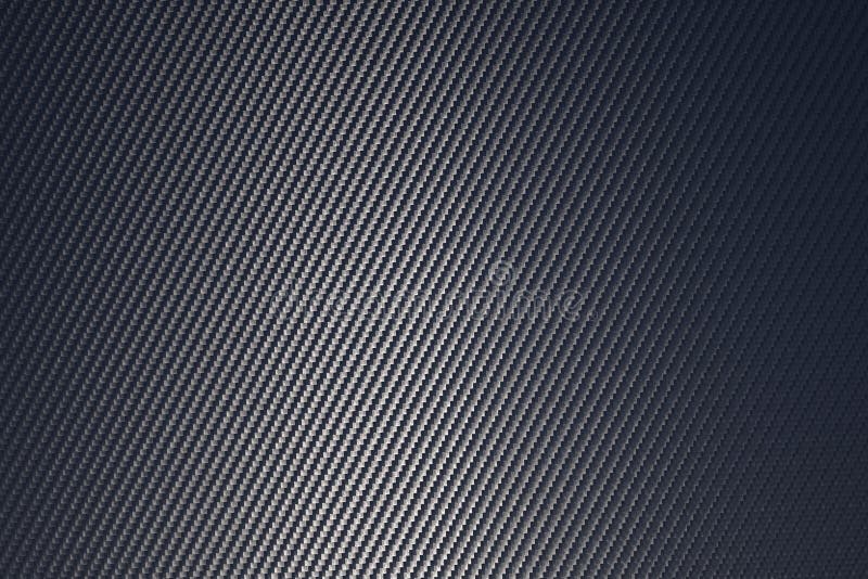 Grey Woven Carbon Fibre Sheet Surface with Light Reflection. Stock