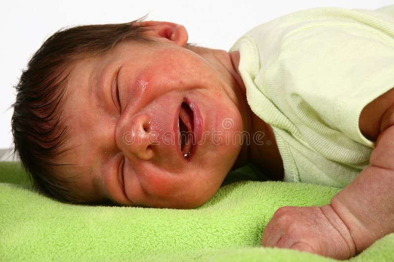 Adorable newborn crying, laying on blanket. Adorable newborn crying, laying on blanket.