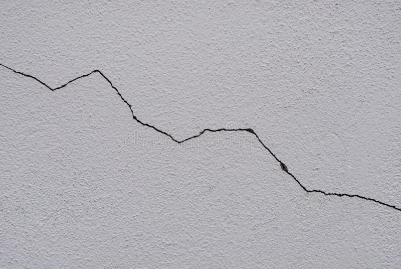 Grieta en la pared enyesada blanco imágenes de archivo libres de regalías Grieta en la pared enyesada blanco imágenes de archivo libres de regalías