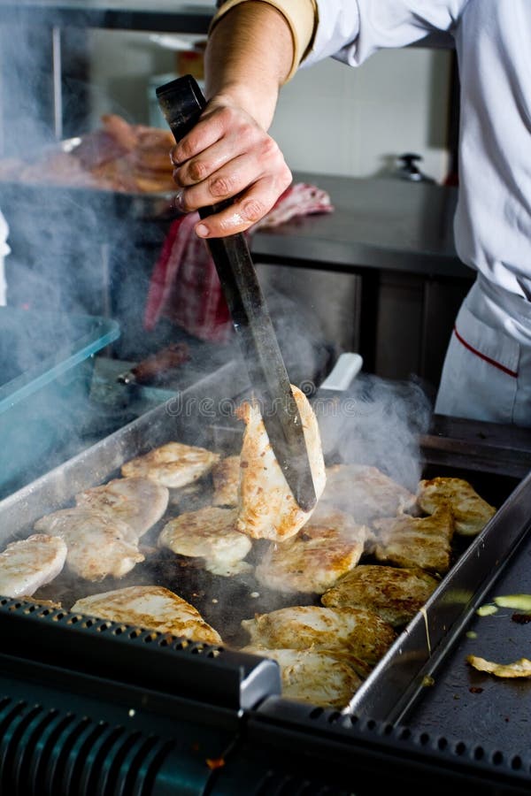 Meat is being cooked on a grill. Meat is being cooked on a grill