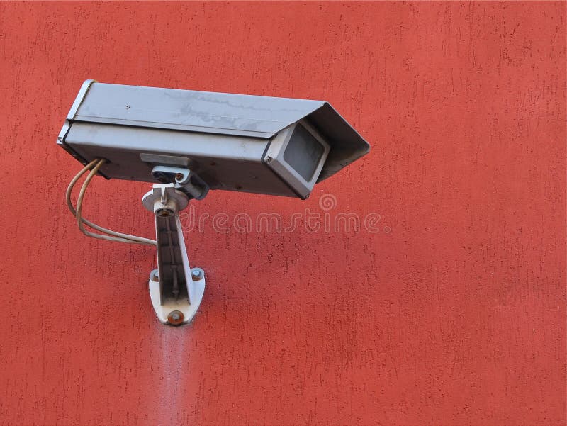 Grijze straatcamera van externe supervisie op een terracotta gekleurde de bouwmuur royalty-vrije stock afbeeldingen Grijze straatcamera van externe supervisie op een terracotta gekleurde de bouwmuur royalty-vrije stock afbeeldingen
