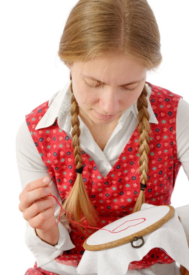 Gril with plaits embroidering red heart