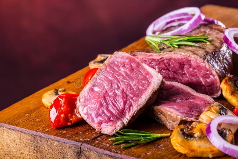Grill beef steak. Portions thick beef juicy sirloin steaks on grill teflon pan or old wooden board. Beefsteak, ingredient.