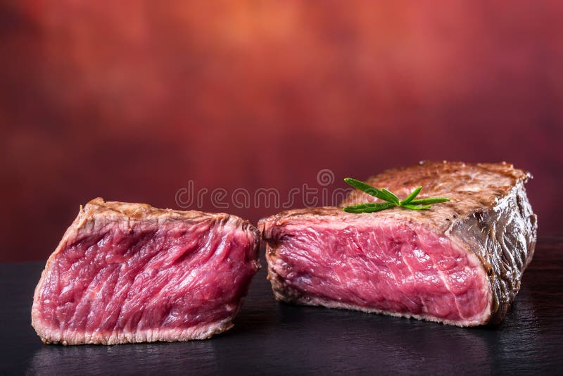 Grill beef steak. Portions thick beef juicy sirloin steaks on grill teflon pan or old wooden board. Background, cooking.