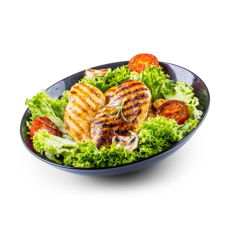 Grilla det grillade fega bröstet och grilla det fega bröstet med grönsallatsalladtomater och champinjoner som isoleras på vit arkivbild Grilla det grillade fega bröstet och grilla det fega bröstet med grönsallatsalladtomater och champinjoner som isoleras på vit arkivbild
