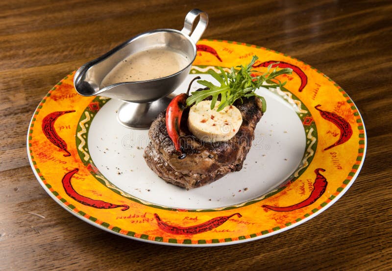 Grilled Beef Steak with Cheese and Pepper Sauce on Plate Stock Image