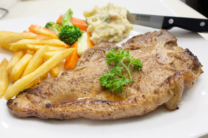 Grilled Beef Steak on White Plate stock images