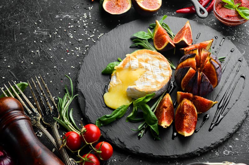 Grilled Brie Cheese with Figs and Basil on a Black Stone Plate. Top View Stock Image Image of