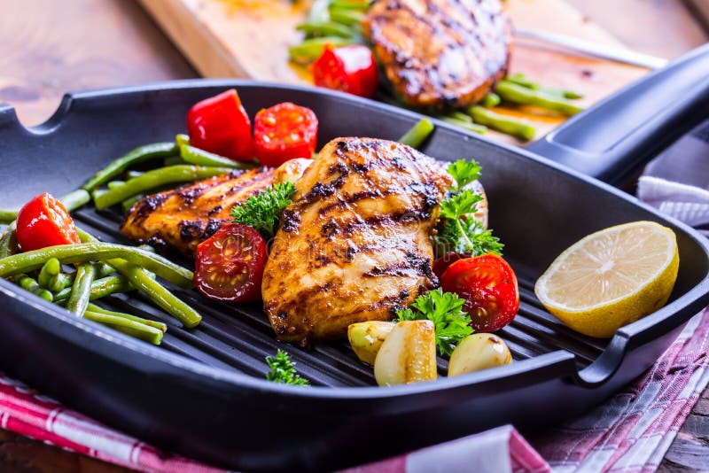 Grilled chicken breast in different variations with cherry tomat