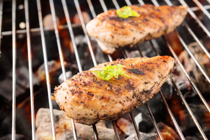 Grilled chicken breast on the flaming grill