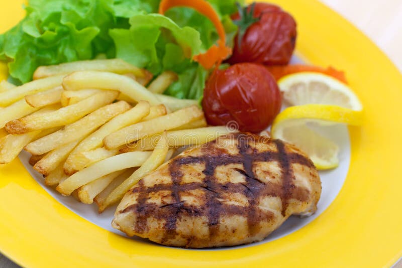 Grilled chicken breast with french fries ,baked to