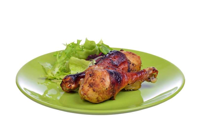 Grilled chicken drumstick with vegetables on the plate