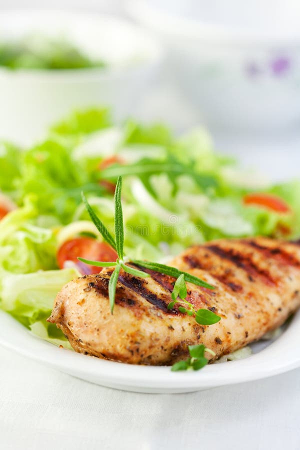 Grilled chicken with herbs and salad