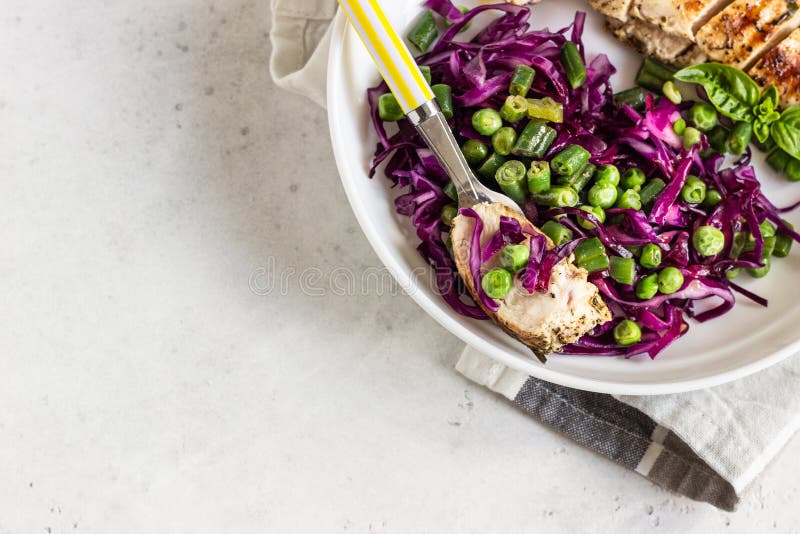 Grilled Chicken, Red Cabbage, Green Peas and Beans on Light Background