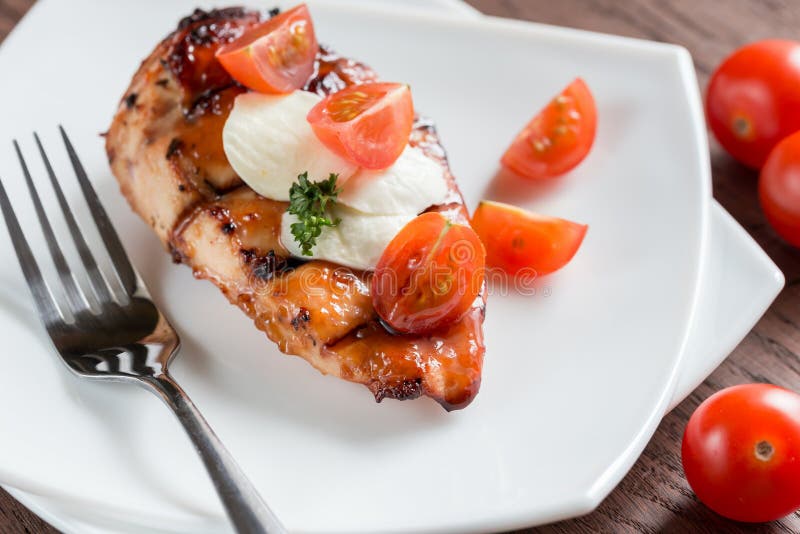Grilled chicken steak with mozzarella and cherry tomatoes