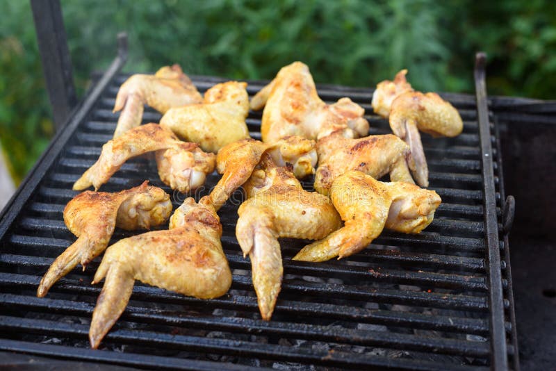 Grilled Chicken Wings on a Barbecue Grill in the Yard Stock Photo