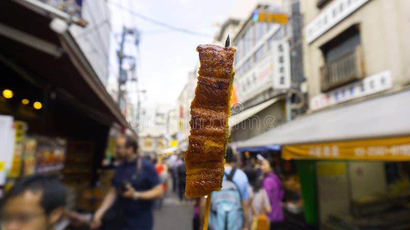 Grilled eel stick sold at Tsukiji fish market at Tokyo, Japan