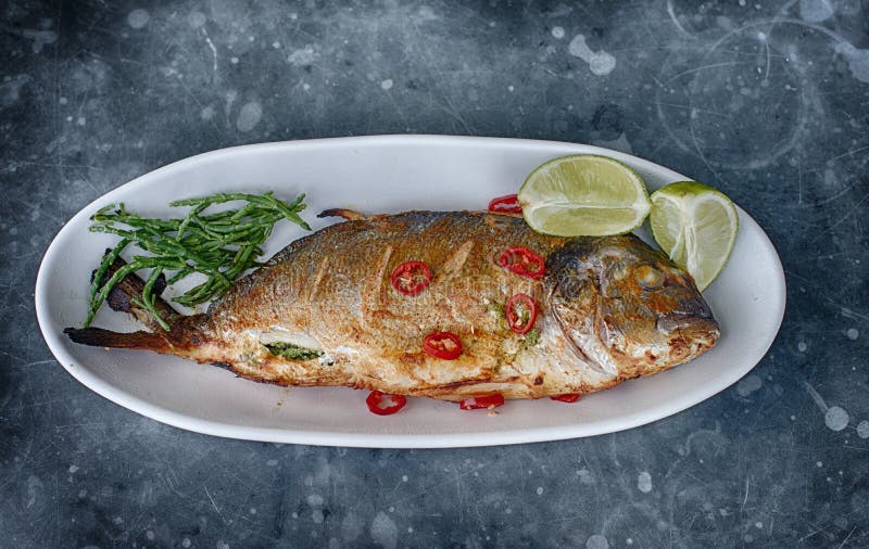 Grilled fish with garnish stock image. Image of cuisine 21976117
