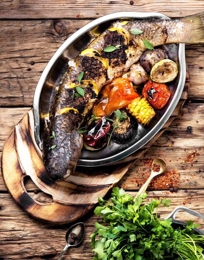 Grilled fish in a tray stock photo. Image of fish, tomato 100887982