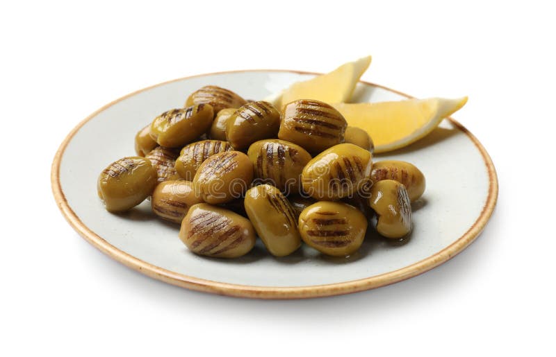 Grilled green olives and lemon wedges isolated on white stock photo