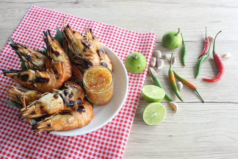 Grilled lobster with seafood sauce and ingredients. Grilled lobster with seafood sauce and ingredients on wooden table stock images Grilled lobster with seafood sauce and ingredients. Grilled lobster with seafood sauce and ingredients on wooden table stock images