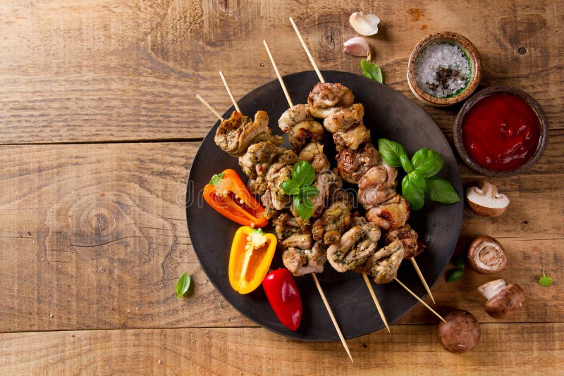 Grilled meat (kebab) with vegetables and sauce