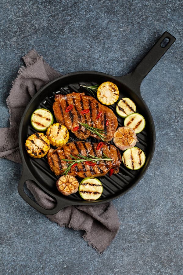 Grilled Meat with Vegetables in a Cast Iron Grill Pan. Grilled Pork