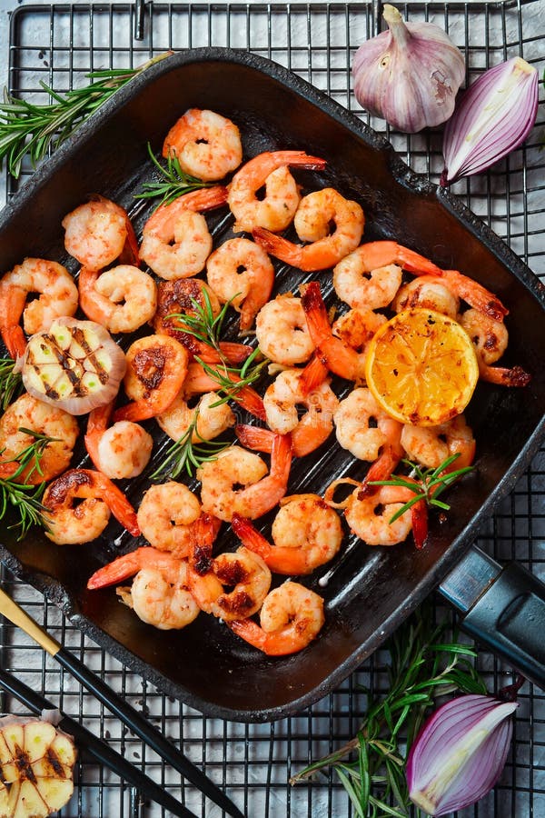 Grilled pan with fried shrimp. Seafood.
