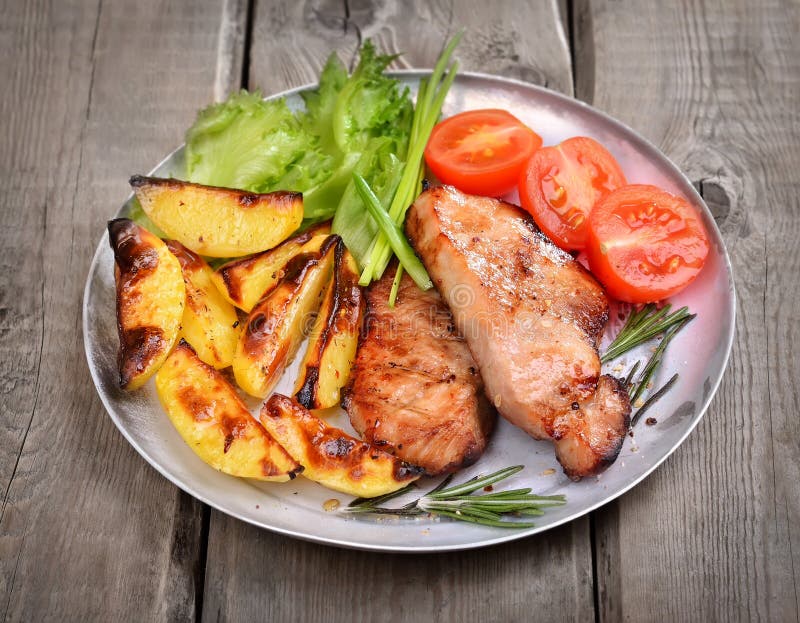 Grilled Pork Chop with Baked Potatoes Stock Photo - Image of cooked ...