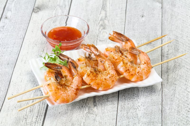 Grilled prawn skewer with sauce