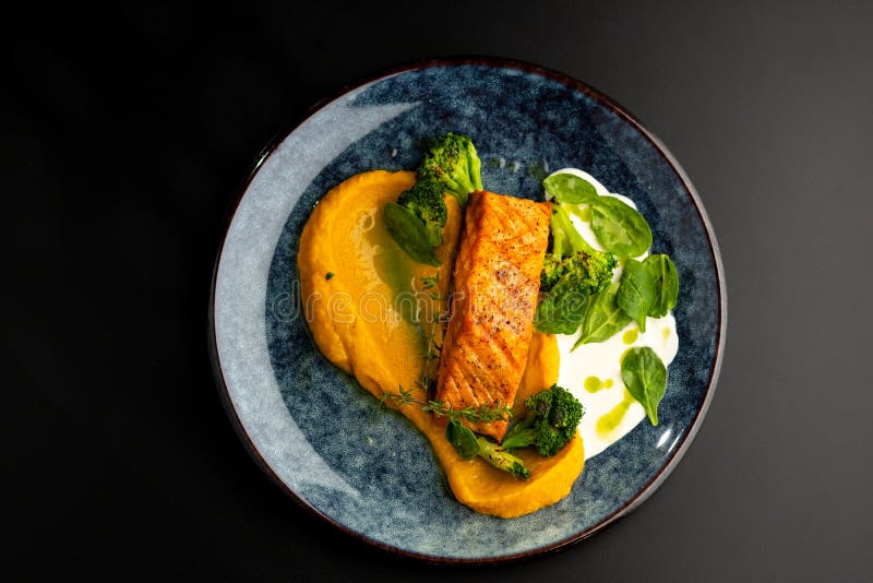 Grilled Red Fish Fillets Salmon With Vegetable Puree And Spinach Stock grilled-red-fish-fillets-salmon-with-vegetable-puree-and-spinach-stock