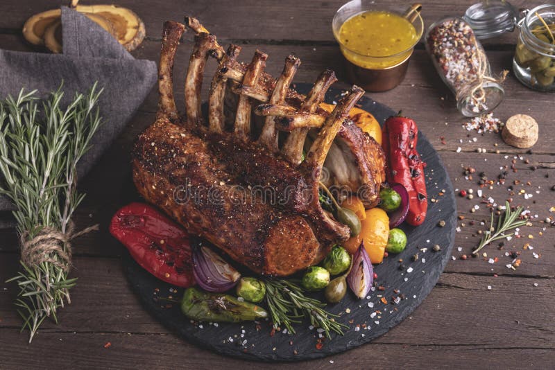 Grilled Roasted Rack of Lamb Veal Chops with Vegetables, on a Wooden