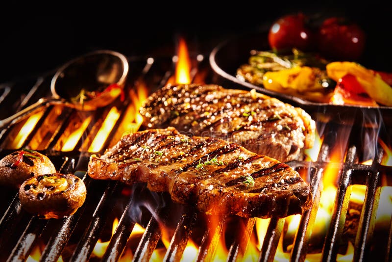 Grilled rump steak with mushrooms over flames royalty free stock images Grilled rump steak with mushrooms over flames royalty free stock images