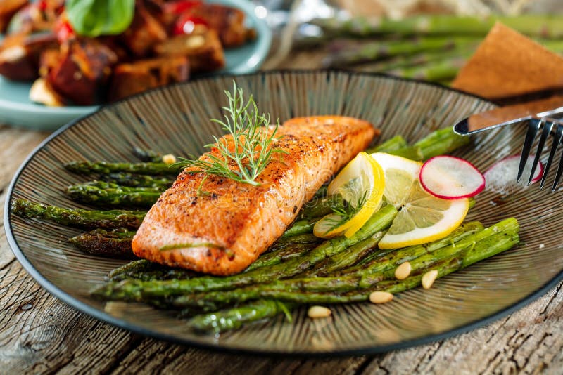 Grilled Salmon and Asparagus on Wooden Table Close Up Stock Image