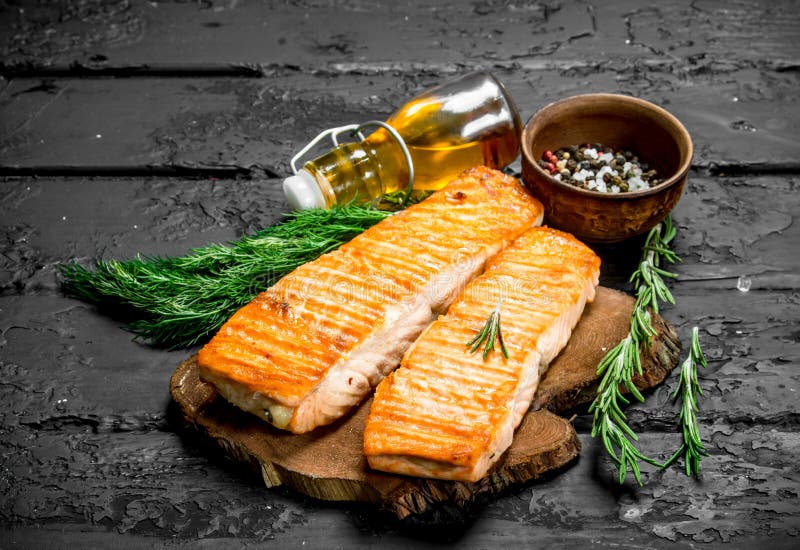 Grilled salmon fillet with spices and dill branches