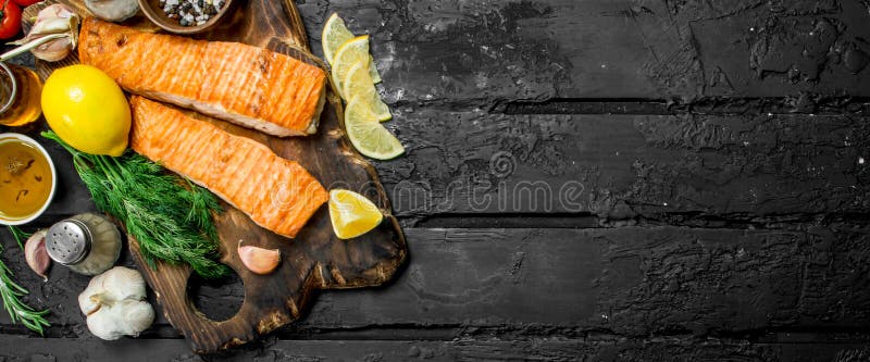 Grilled salmon fillet with spices, herbs and branches of fresh dill