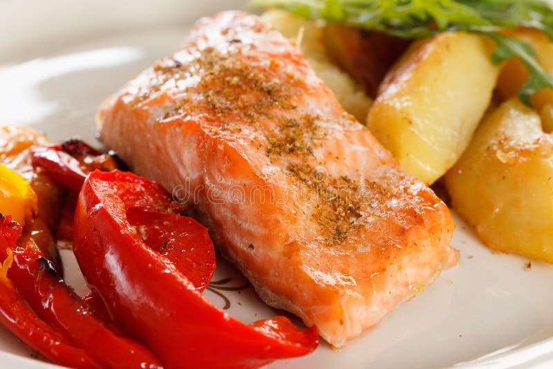 Grilled Salmon Fillet with Vegetables, Spices and Arugula on a Plate ...