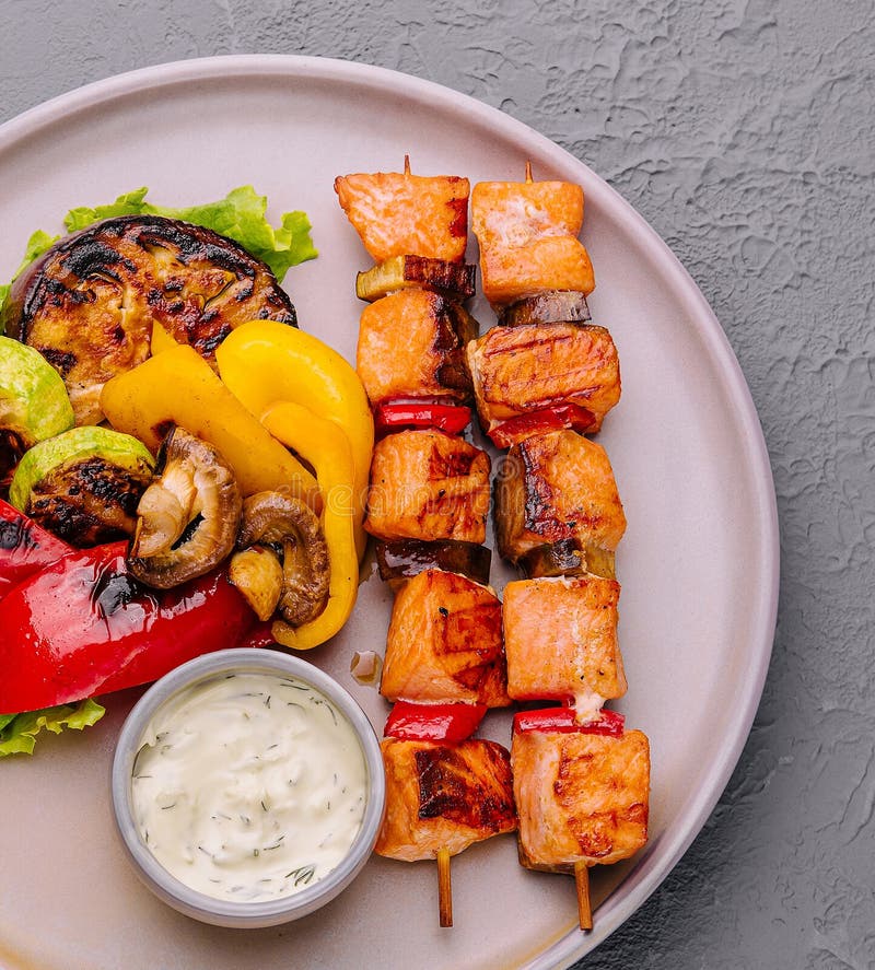 Grilled Salmon Fish Kebab Skewers with Grilled Vegetables Stock Photo
