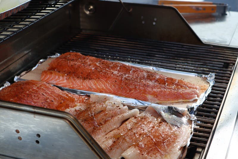 Grilled Salmon On The Flaming Grill. Fresh Raw Salmon Fillet On Wooden Board Wrapped In Foil ...