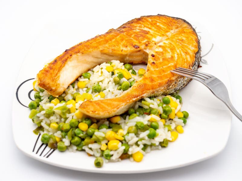 Grilled salmon with rice and vegetables stock image