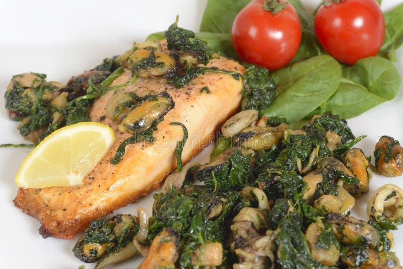 Grilled salmon with seafood and spinach