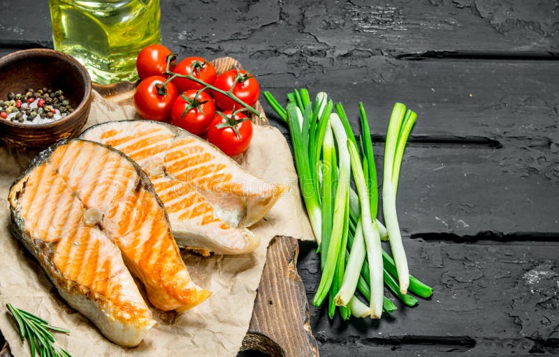 Grilled salmon steaks with spices and green onions