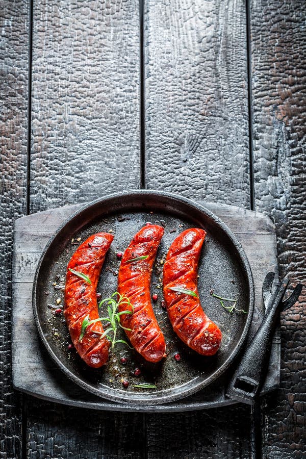Grilled Sausage with Fresh Herbs on Hot Barbecue Dish Stock Image