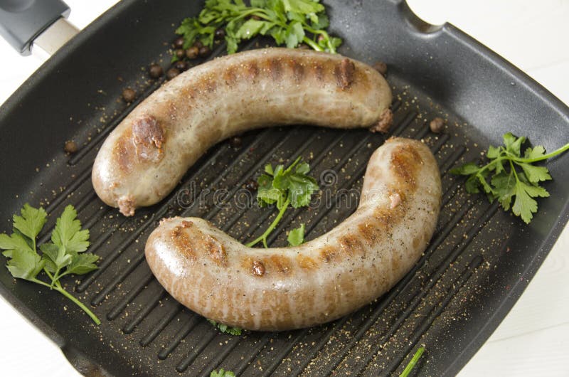 Grilled sausages in pan stock image. Image of sausages 69525535