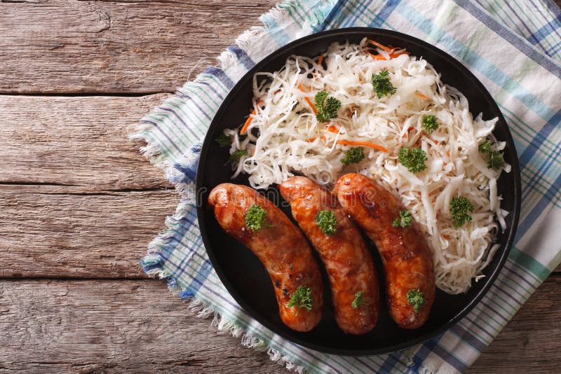 Grilled sausages and sauerkraut close-up. Horizontal top view