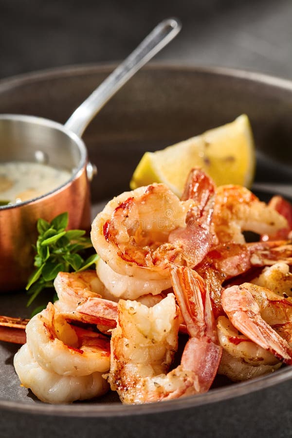 Grilled shrimp with garlic and sauce, bright lighting, closeup composition stock photo