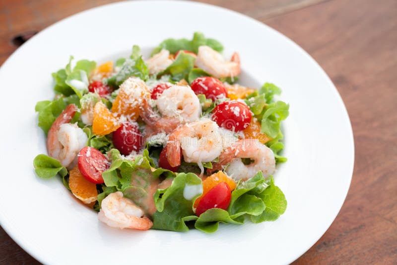 Grilled shrimp salad on wood table stock photo