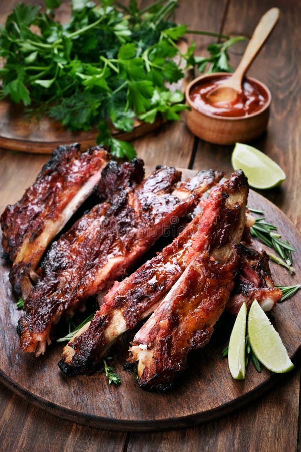 Traditional Barbecue Pork Ribs Served with Spicy Sauce and Lemon Close